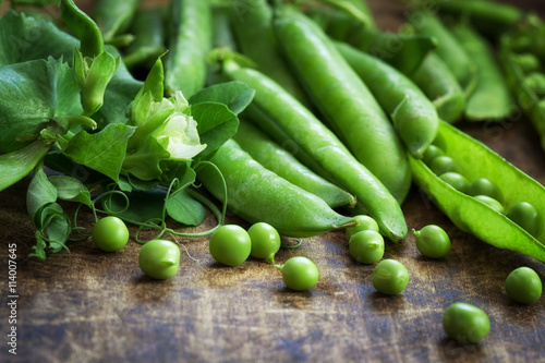 Ripe Green peas on wooden table