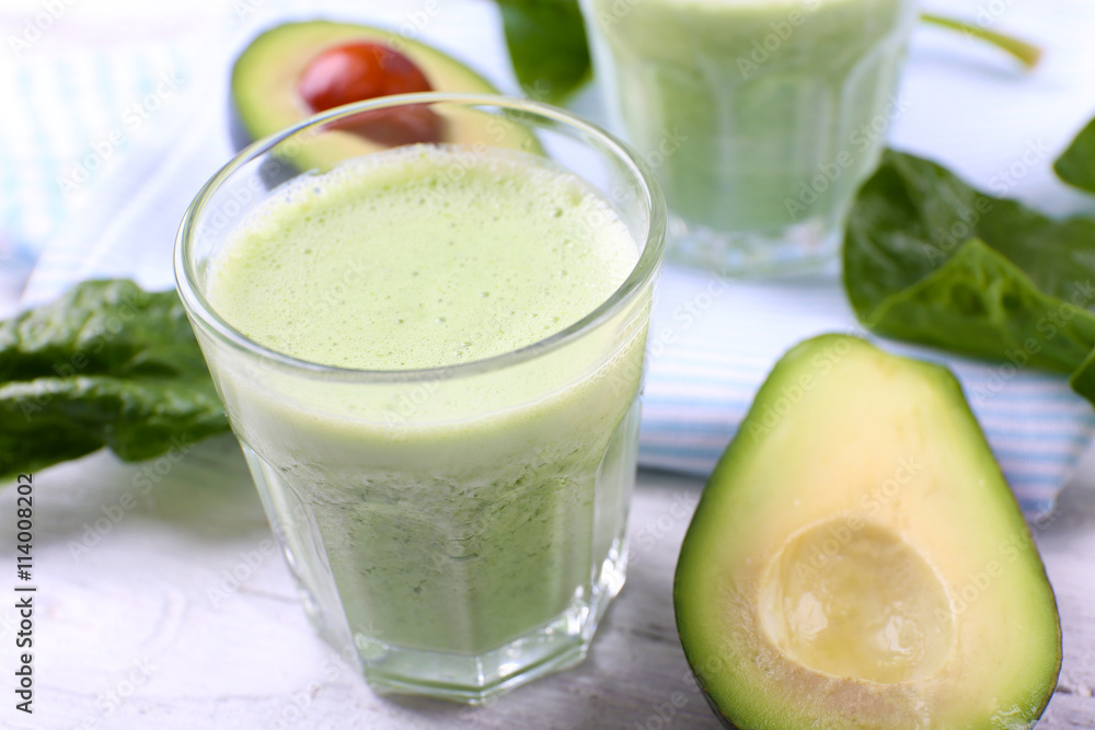 Delicious fresh avocado smoothie on white wooden background Delicious fresh avocado smoothie on white wooden background