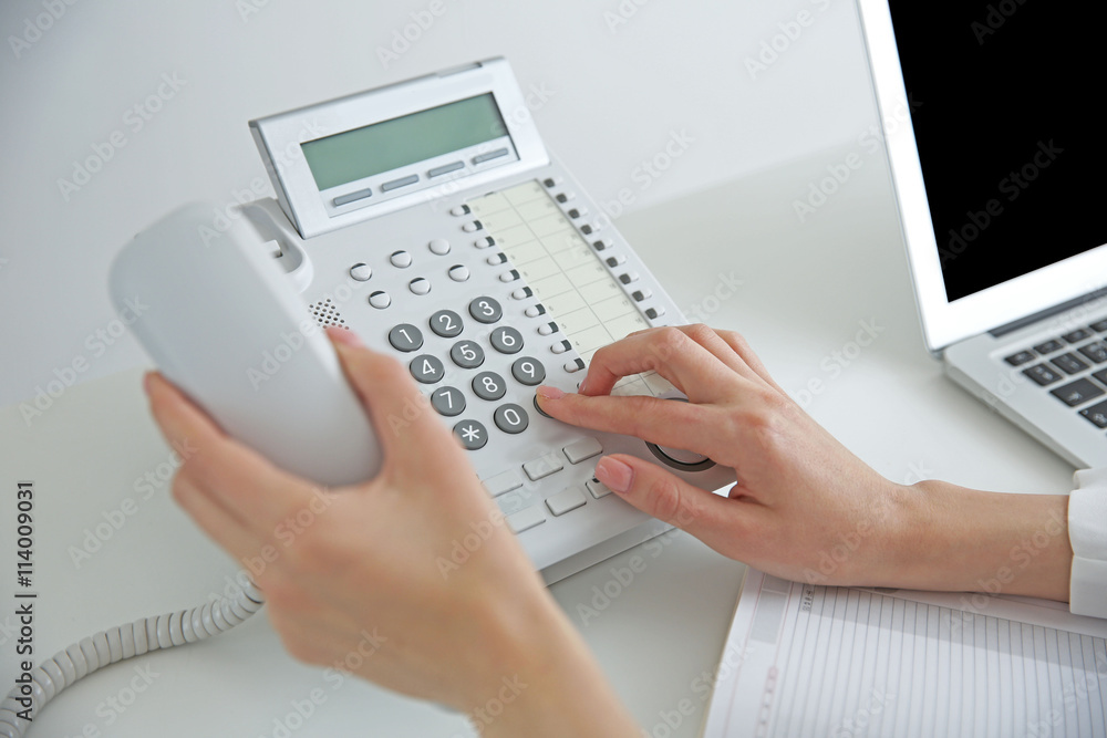 Businesswoman with office IP telephone Businesswoman with office IP telephone
