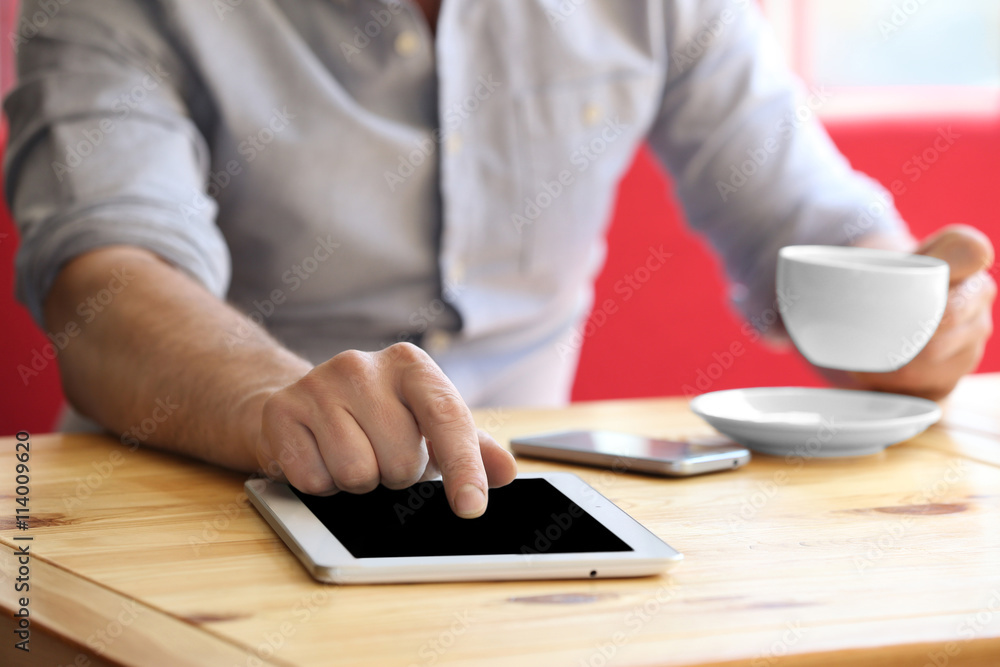 Businessman with tablet in cafe Businessman with tablet in cafe
