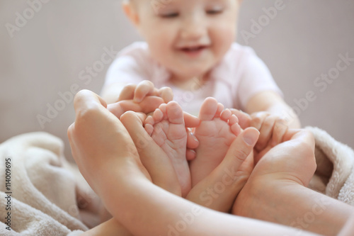 Woman holding small baby feet