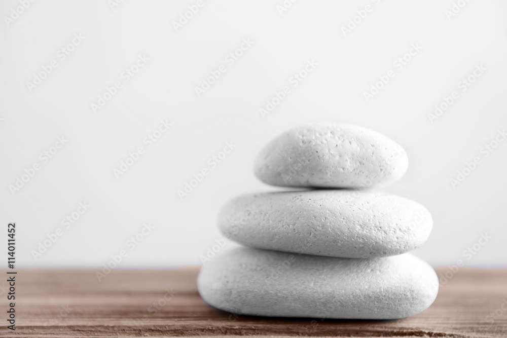Fotografie White spa stones on light background