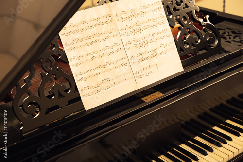 Musical notes on black pian...