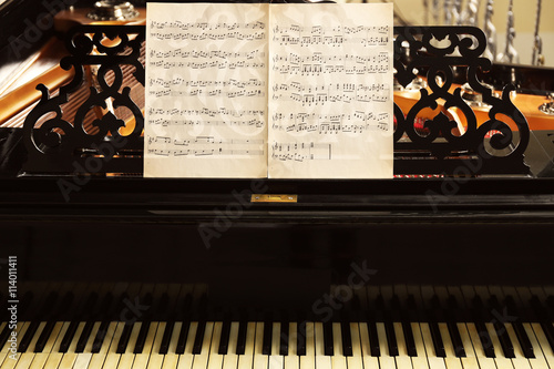 Musical notes on black pian...