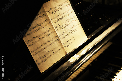 Musical notes on black pian...