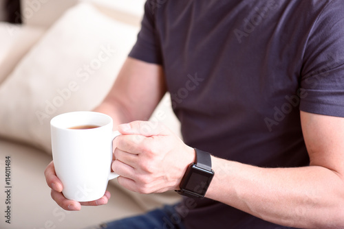Hands holding cup of tea