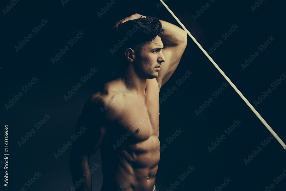 Fotografie Muscular man near window