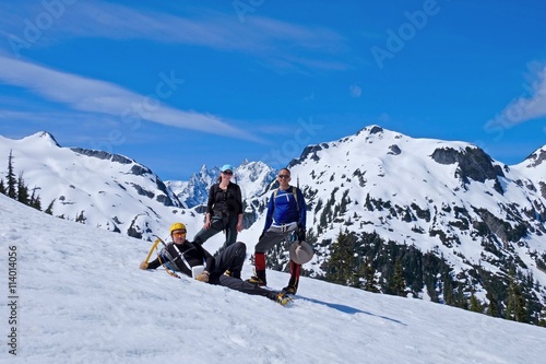 Group of happy friends climbers on mountain top. Mount Shuksan, North Cascades National Park, Washington State, USA. 