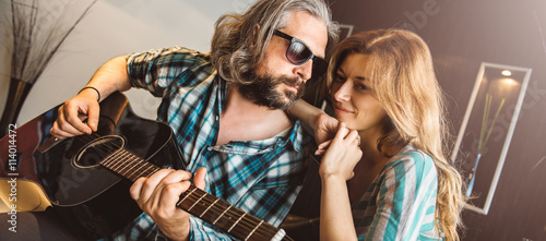 Romantic man playing guitar for his woman