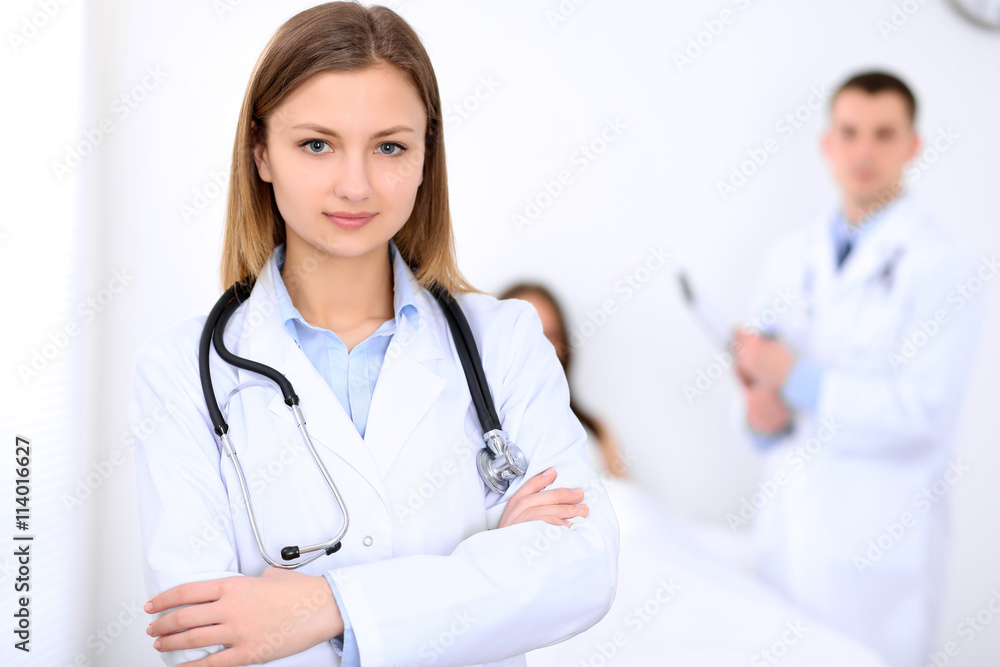Friendly female doctor on the background with patient in the bed and his doctor Friendly female doctor on the background with patient in the bed and his doctor