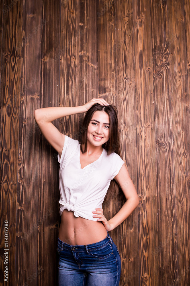 Fototapeta premium Young girl with nice smile against wooden wall