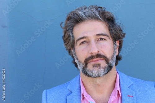 Portrait of mature business man with grey beard and hair alone with copy space photo