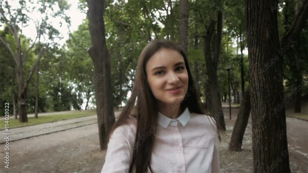 Follow me girl concept. Young pretty happy student model smiling and walking in park. Follow me girl concept. Young pretty happy student model smiling and walking in park.