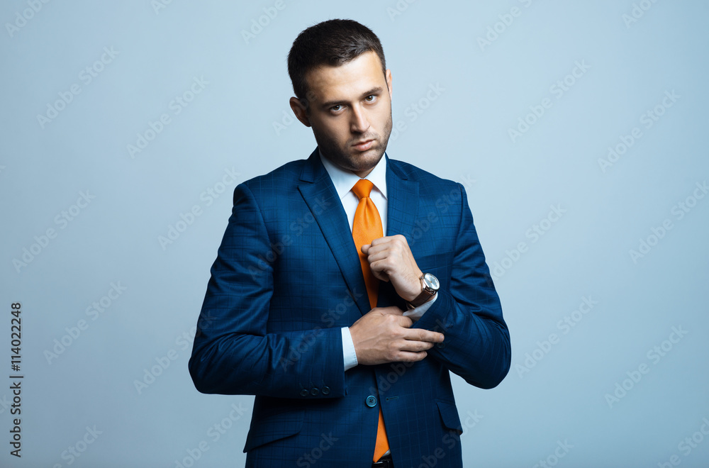 Stylish young man in suit and tie. Business style. Fashionable image. Office worker. Sexy man standing and looking at the camera