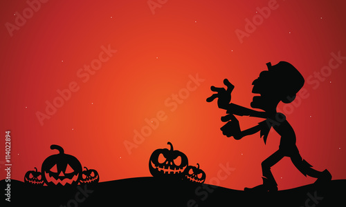 Silhouette of Halloween zombie and pumpkins