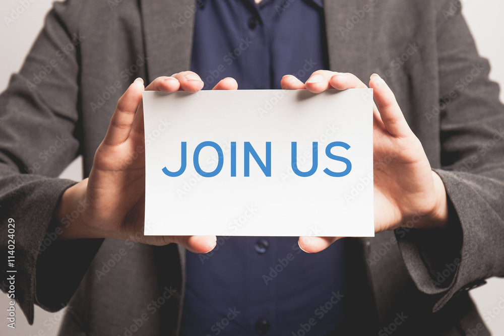 Young businesswoman holding join us card.