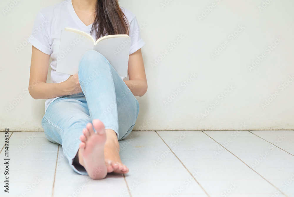 Woman sitting at the corner of house for reading a book in free Woman sitting at the corner of house for reading a book in free