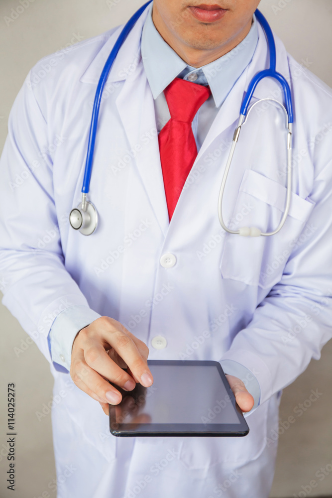 Doctor using tablet in white isolated background Doctor using tablet in white isolated background