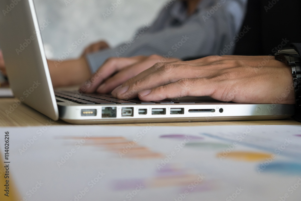 Close-up of young female hands pressing laptop buttons Close-up of young female hands pressing laptop buttons