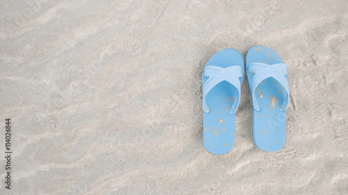 Blue sandals at the beach with copy space