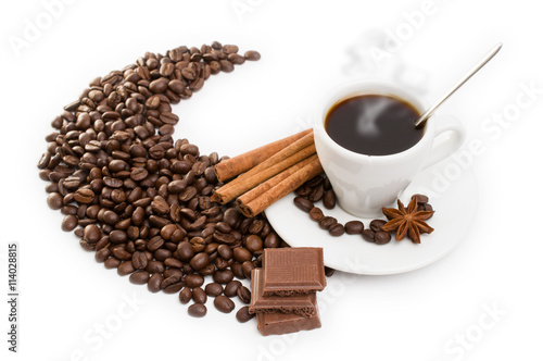cup of coffee with cinnamon sticks, anise and chocolate