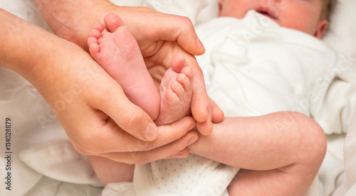 Baby legs. Legs newborn in sister hand