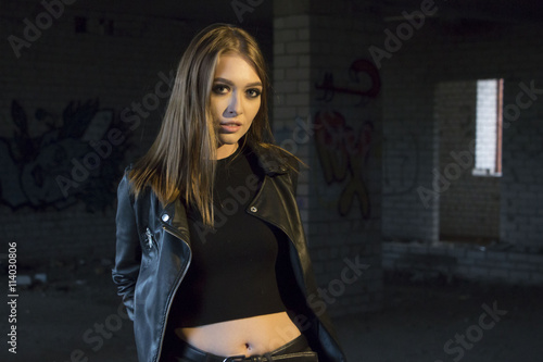 Beautiful teenager girl in a dark hallway