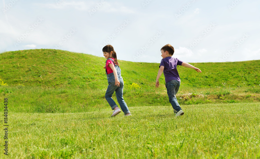 happy little boy and girl running outdoors