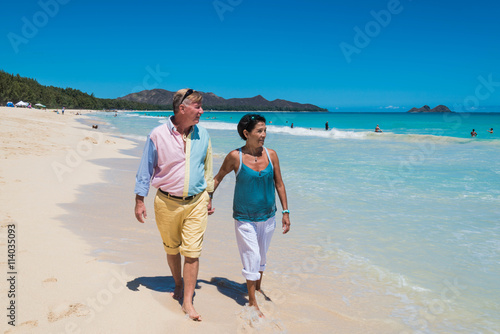 Retirement Couple Strolling Tropical Beach in Hawaii