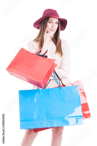 Attractive young female holding many shopping bags and smiling
