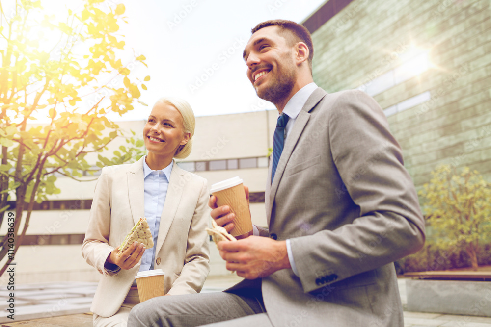 smiling businessmen with paper cups outdoors smiling businessmen with paper cups outdoors