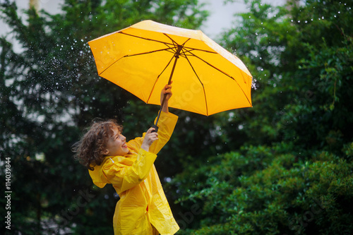 Chappie with a bright yellow umbrella in the warm summer rain.