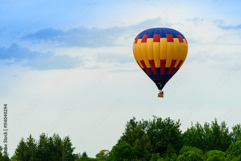 air balloon flight over the trees on a background of clouds