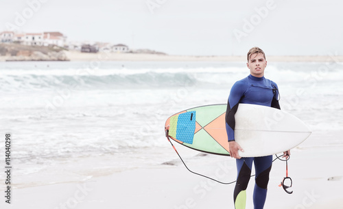 Young surfer on beach