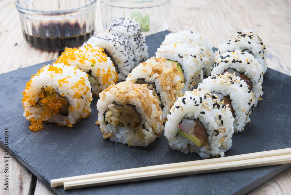 Sushi rolls on a slate plate Sushi rolls on a slate plate