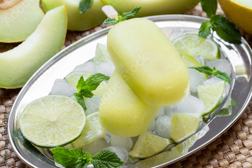 Melon and lime sorbet ice cream popsicles. photo