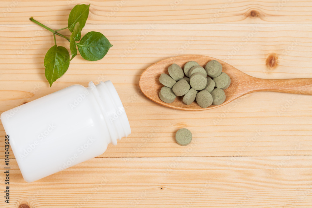 Herbal pill on wooden spoon. herb for healthy living. Herbal pill on wooden spoon. herb for healthy living.