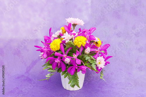 Bouquet of chrysanthemum and orchid flowers isolated on purple v