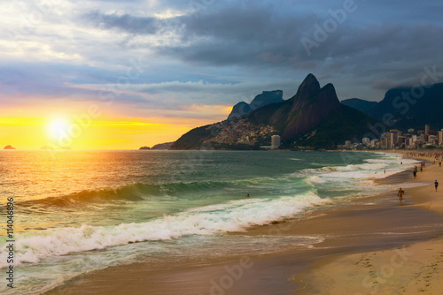 Sunset view of Ipanema beach and mountain Dois Irmao (Two Brother) in Rio de Janeiro, Brazil. Ipanema beach is the most famous beach of Rio de Janeiro