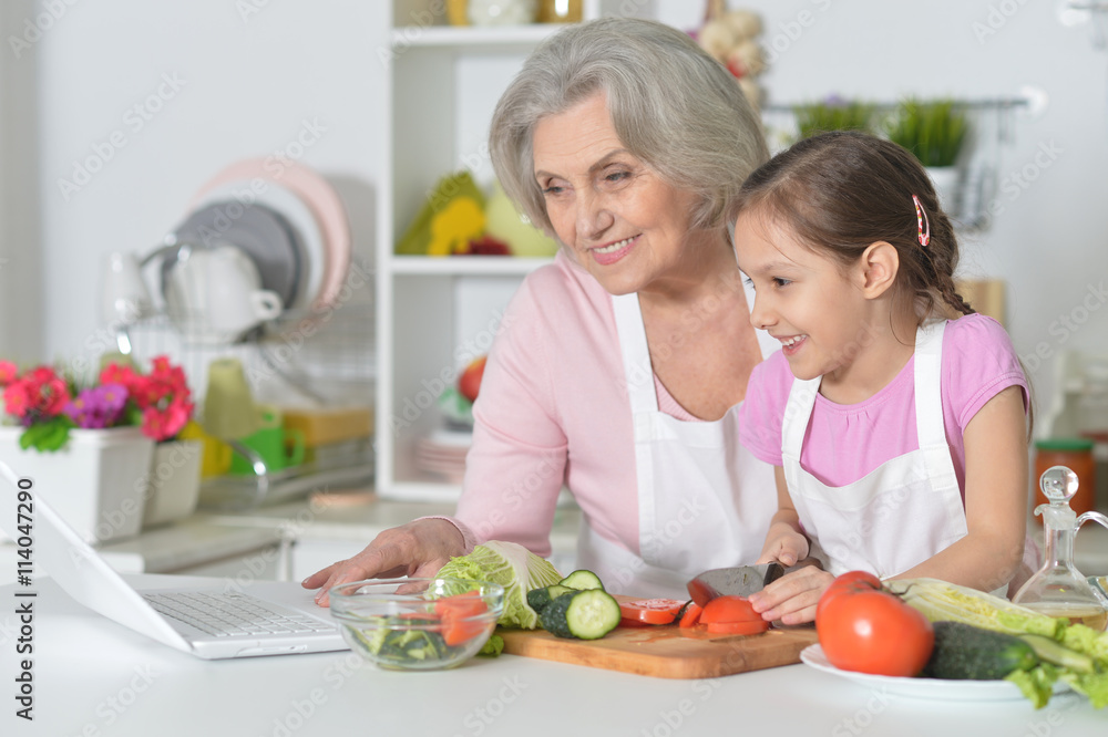 Senior woman with granddaughter cooking Senior woman with granddaughter cooking