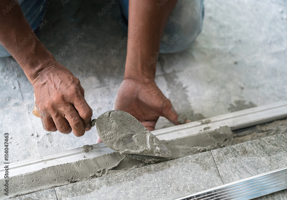construction worker using trowel and mason's float
construction worker using trowel and mason's float