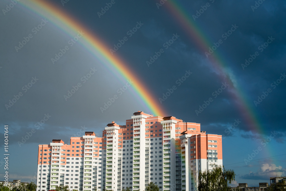 Double Rainbow after rain above the multi-storey house