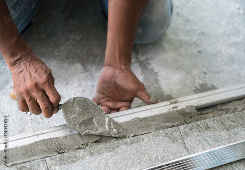 Man mason building a screed coat cement on floor
