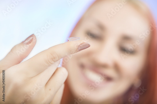 Contact lens  Young woman holding contact lens on finger in fron