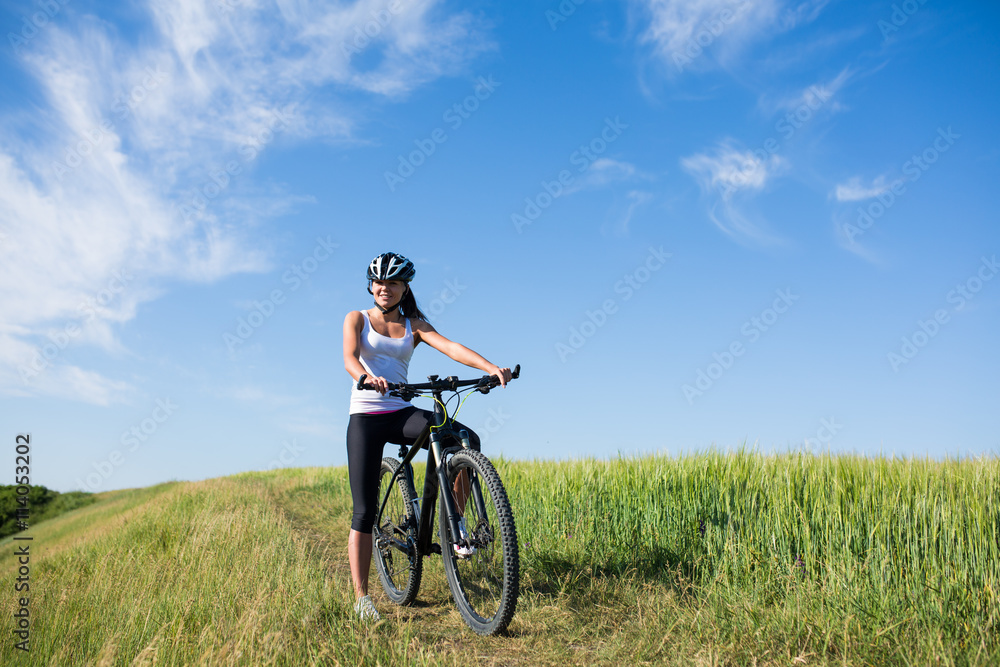 girl rides a bicycle in the countryside