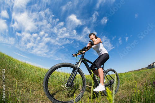 Mountain biking happy sportive girl relax in meadows sunny countryside © Aleksey
