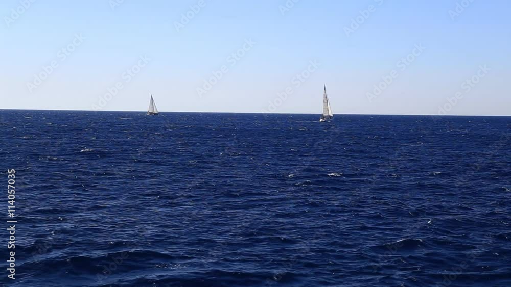 White motor yacht moves away to horizon, leaves water trace White motor yacht moves away to horizon, leaves water trace