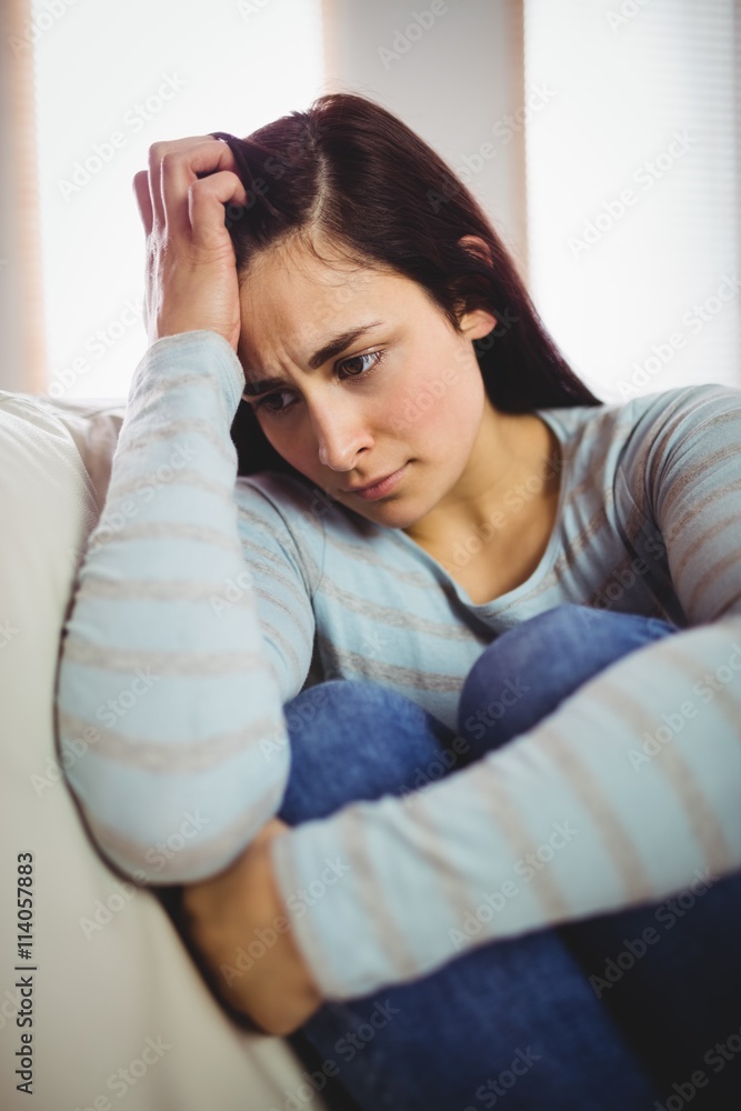 Depressed woman sitting at home Depressed woman sitting at home