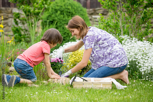 Mother and son gardening together in their little garden