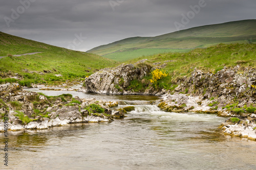 River Coquet cascades down Coquetdale, flowing from the Cheviot Hills in Northumberland